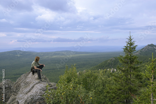 Man hiker on a top of a mountain in the national park of nature Taganay, Russia