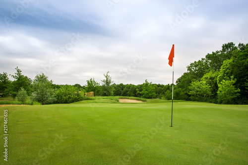 Final hole with flag, lawn on golf course