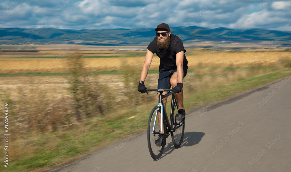 Fototapeta premium Natural view with cyclist going somewhere with stylish bike