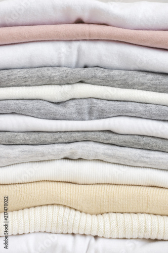 Stacked neutral colored t-shirts
