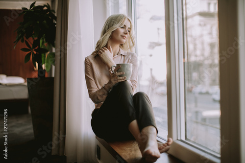 Blonde young woman drinking...