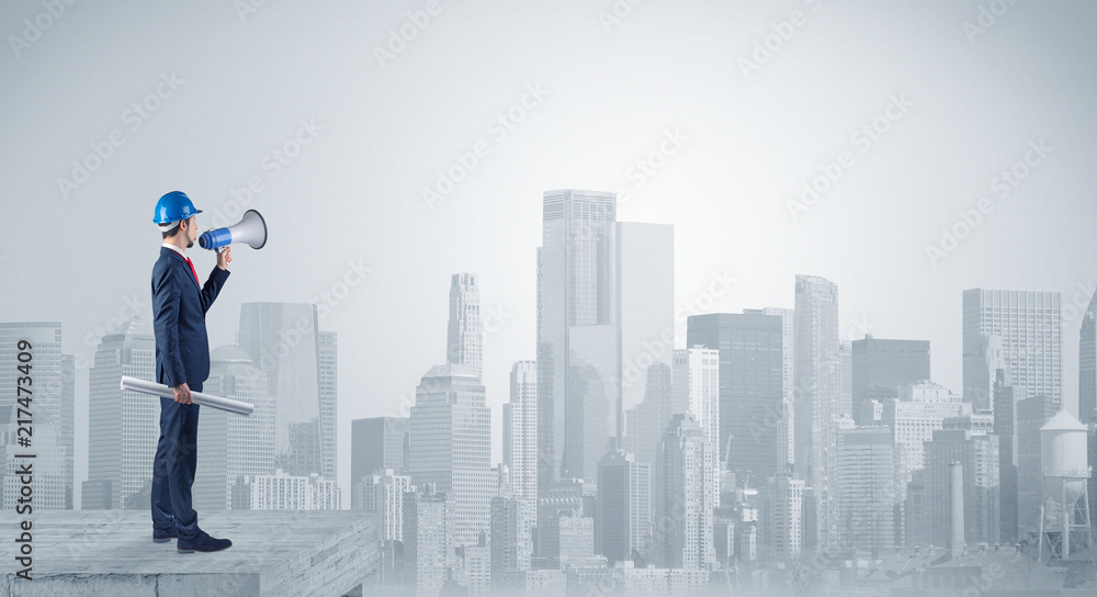 Architect standing on maze and looking at a future plan
