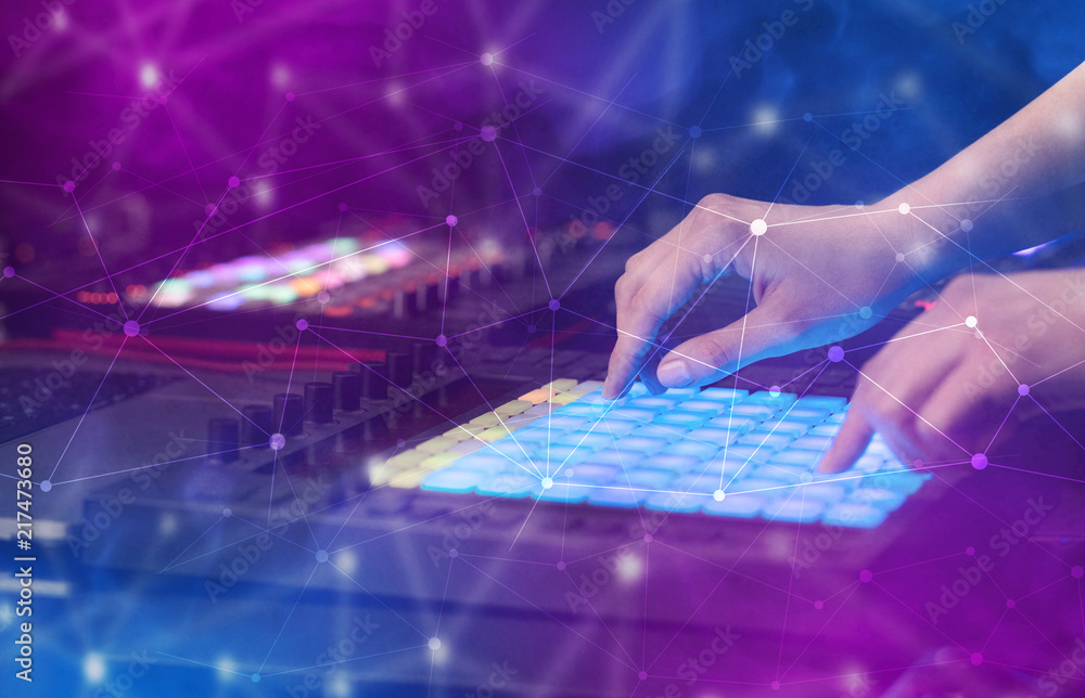 Hand remixing music on midi controller with colorful connectivity concept
