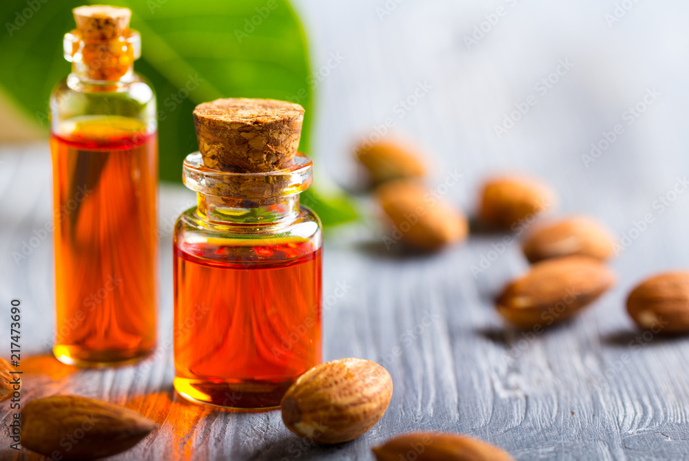 oil almond cosmetic medicine health nature glass vial wooden background
