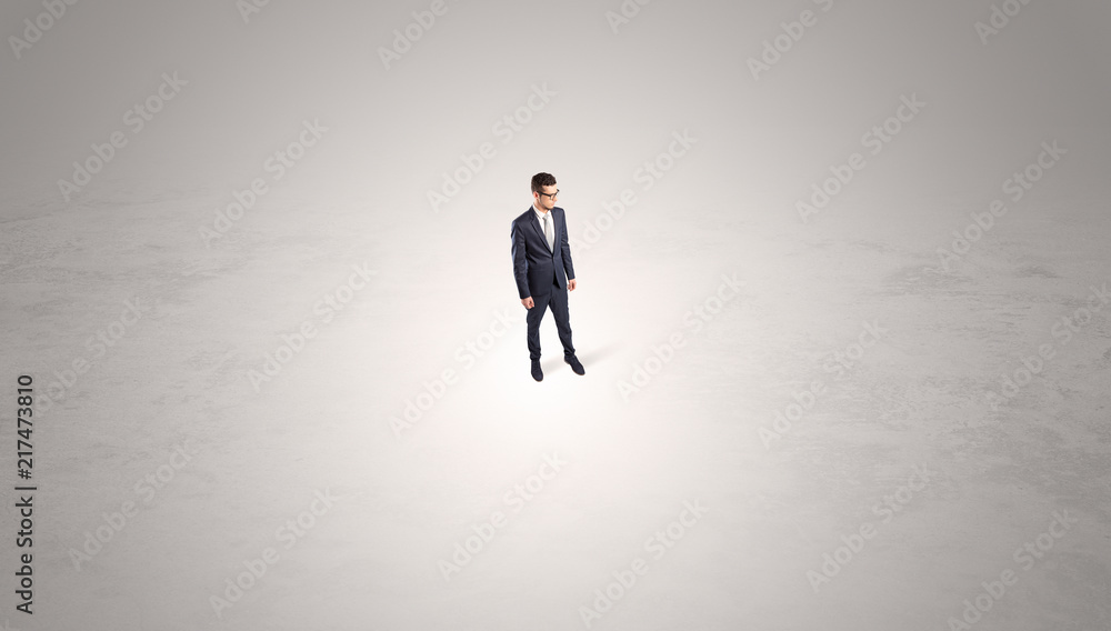 Young businessman standing alone in the middle of an empty space
Young businessman standing alone in the middle of an empty space