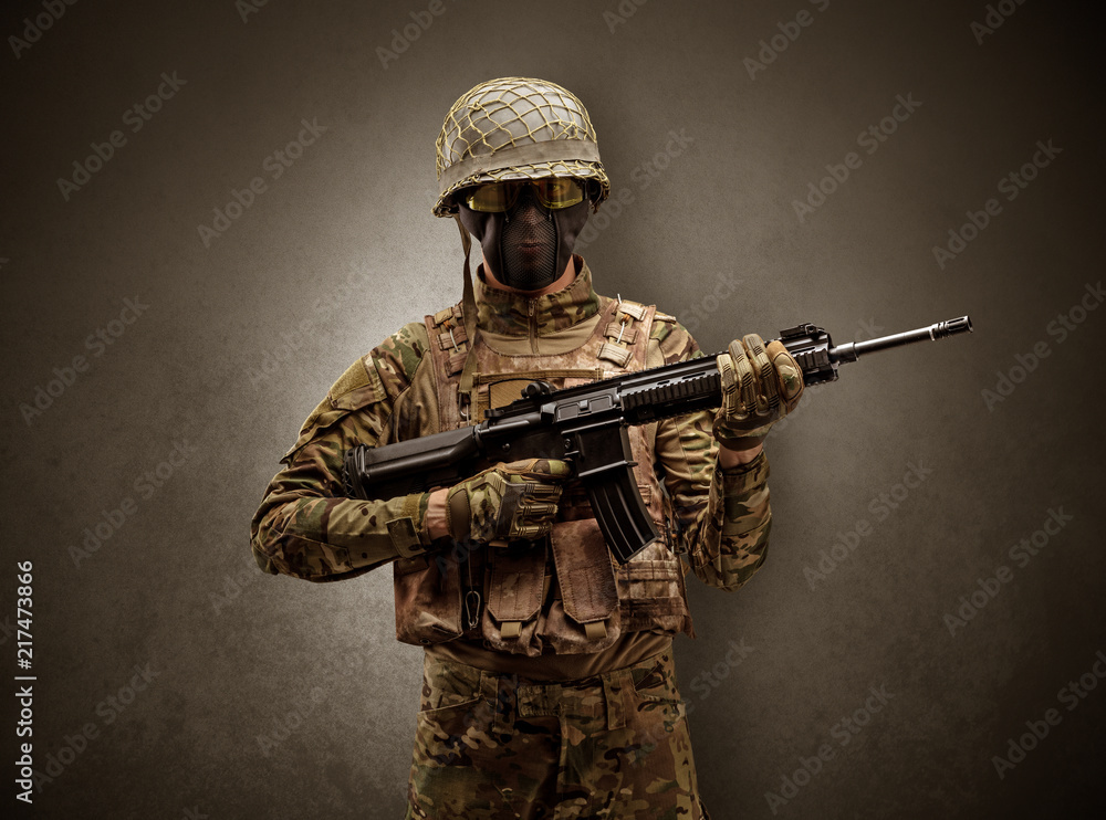 Soldier agent in a dark room with arms on his hand and gas mask
Soldier agent in a dark room with arms on his hand and gas mask