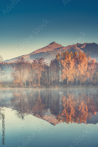 Autumn trees and mountains reflection in lake © marcin jucha