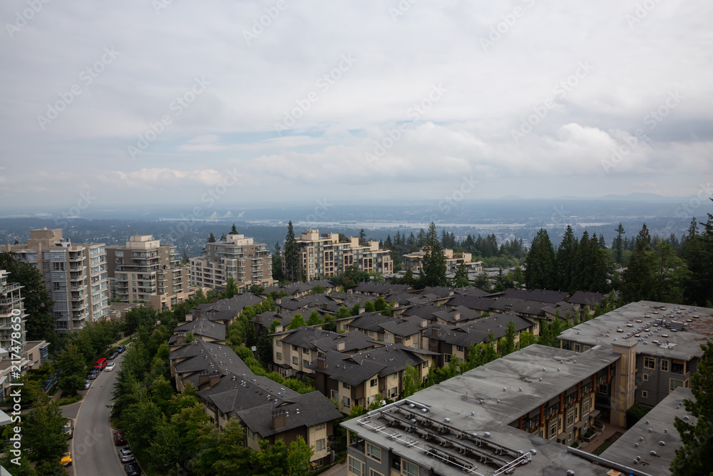 Fototapeta premium Aerial view of residential homes and buildings on top of Burnaby Mountain. Taken in Vancouver, British Columbia, Canada.