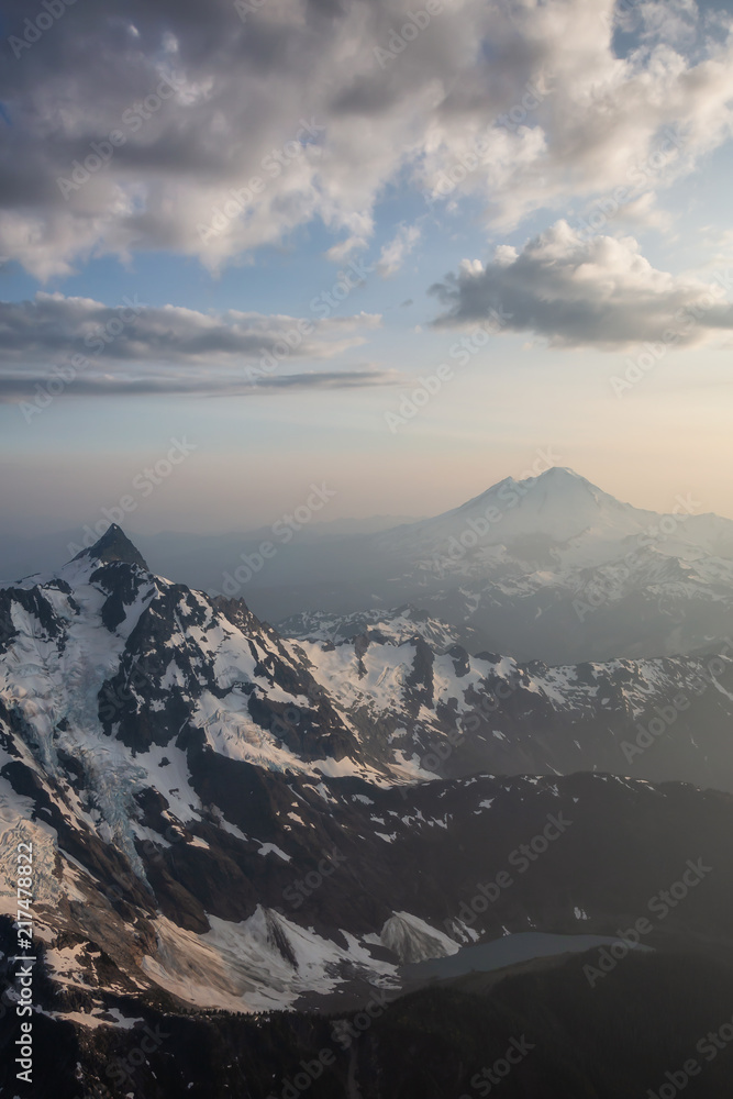 Aerial landscape view of the rugged mountain peaks with Mount Baker in the background. Located Northeast of Seattle, Washington, United States of America.