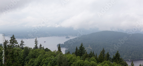 Aerial panoramic view of Belcarra and Deep Cove during a cloudy summer day. Taken from the top of Burnaby Mountain, Vancouver, BC, Canada.