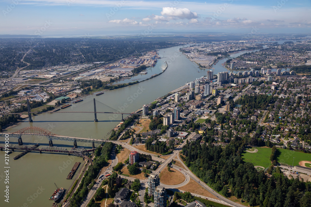 Obraz premium Aerial city view of Pattullo and Skytrain Bridge across the Fraser River. Taken in Greater Vancouver, British Columbia, Canada.