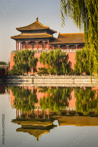 The Meridian or South Gate Watchtower of the Forbidden City in Beijing, China, with a reflection in the moat