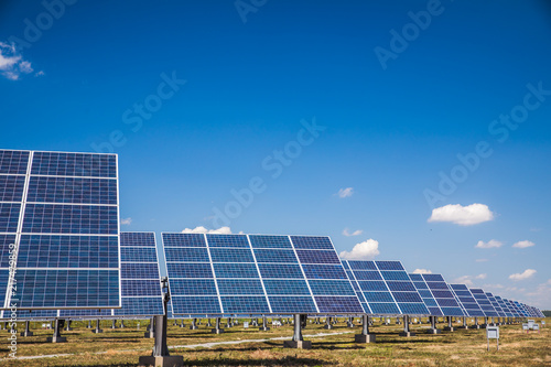 Group of solar panels on a blue sky with clouds
