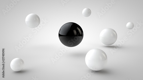 the image of groups of balls with different depth of field  white drop shadow  and randomly located in space  and one black ball in the center  on a white background. 3D rendering.