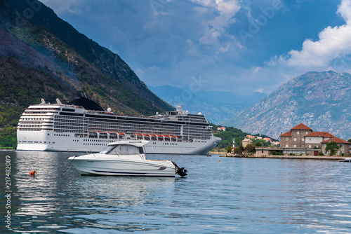 luxury white huge cruiser in seaside passing by the mountain