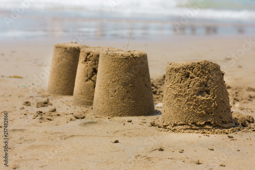 Castle of sand on the beach by the sea