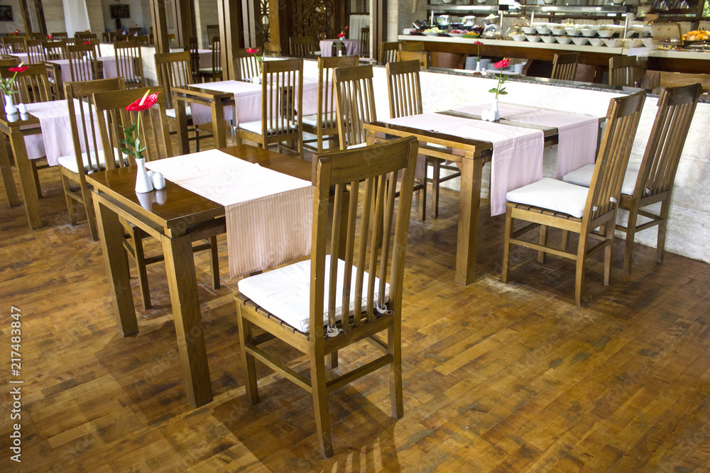 Cozy cafe with a buffet with wooden tables and chairs