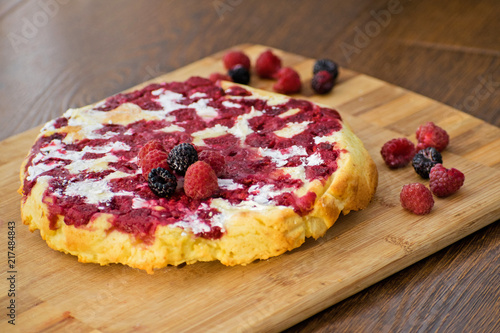 Cheesecake with raspberries and blackberry close-up. Light breakfast.