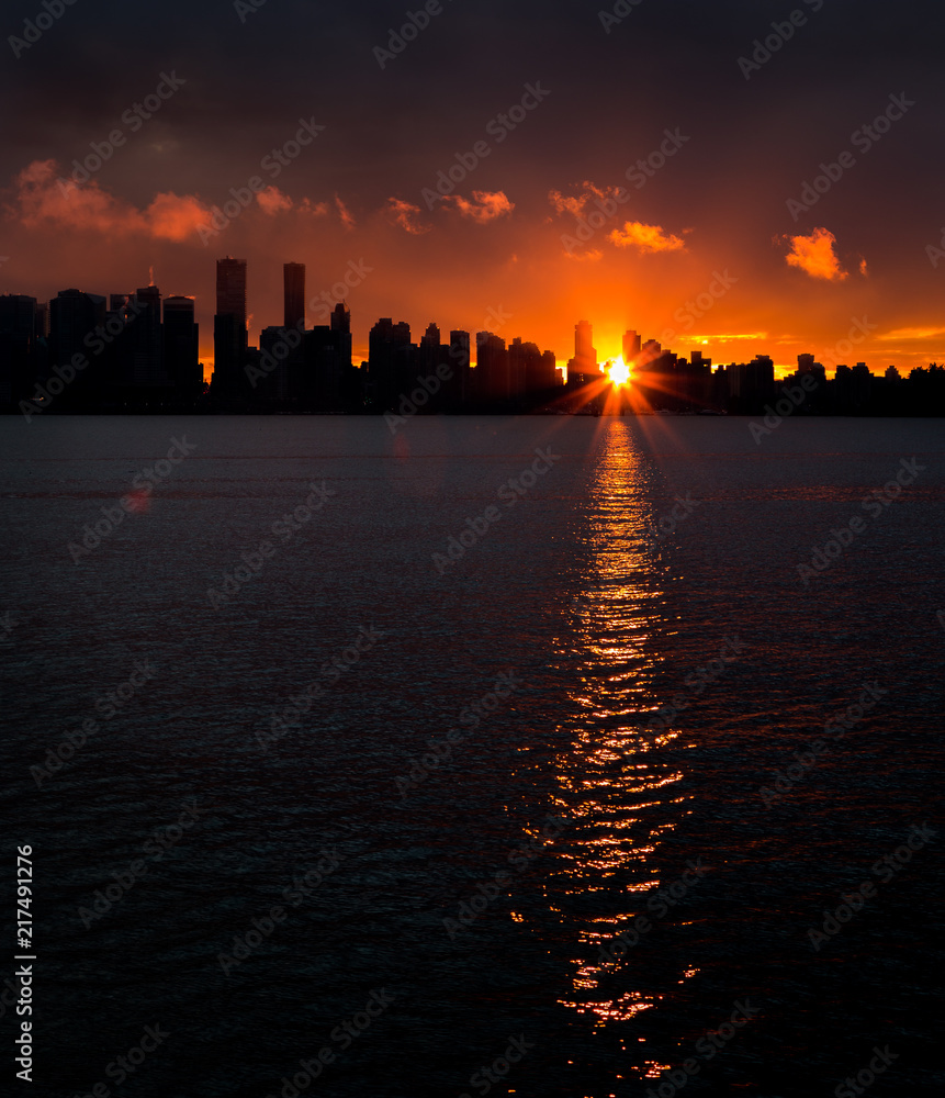 Downtown Vancouver silhouetted against the setting sun. Downtown Vancouver silhouetted against the setting sun.