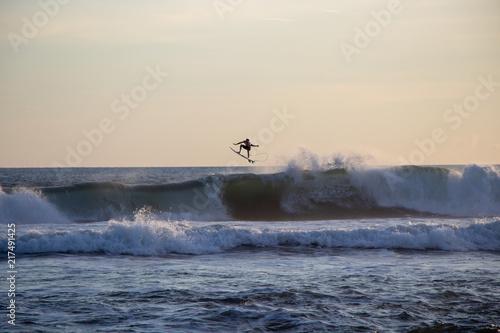 Surfer riding wave at Echo Beach Canggu Bali Indonesia