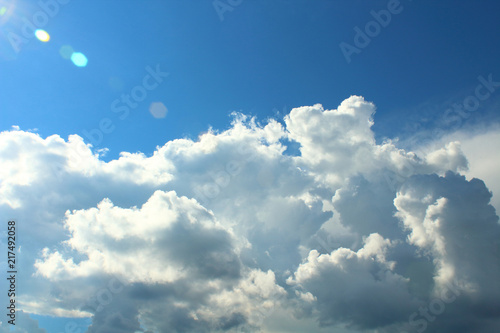 Beautiful large cumulus clouds and sun. Close-up. Background.