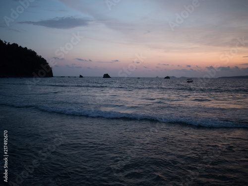 Sunset in the ocean. Lonely empty beach