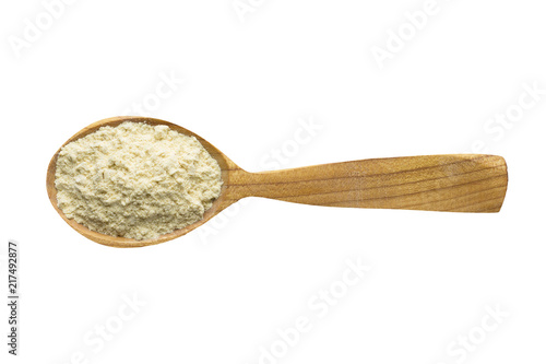 fenugreek powder in wooden spoon isolated on white background. spice for cooking food, top view.