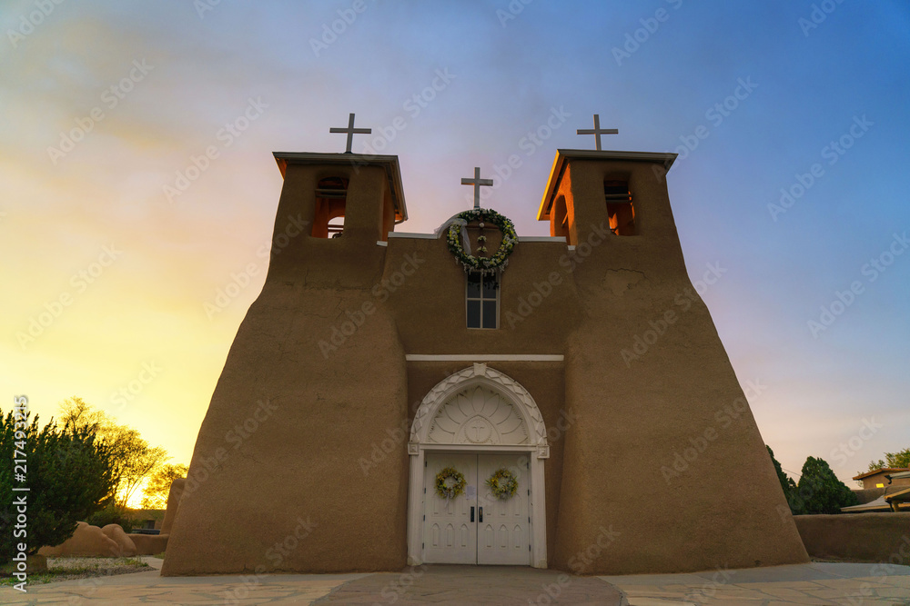 San Francisco de Asis Mission Church, Toas, New Mexico, church, architecture, building, sky, religion, cross, white, blue, old, travel, tower, bell, pastel, catholic, landmark, chapel, village, dome