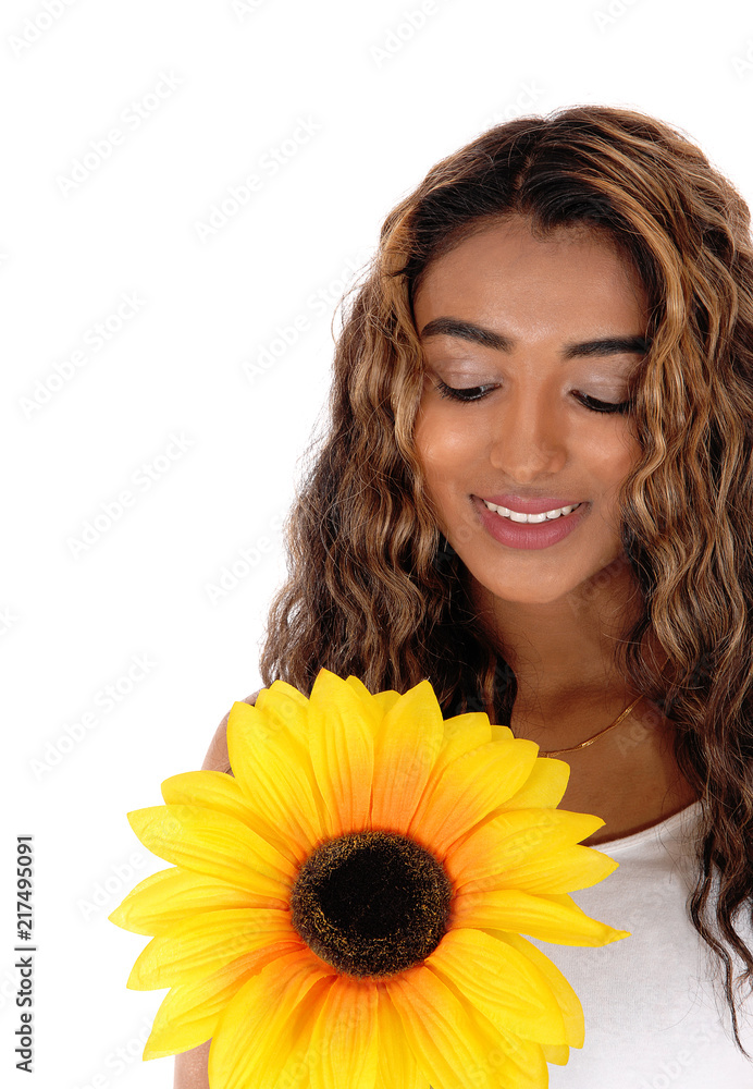 Beautiful teenager looking at the sunflower