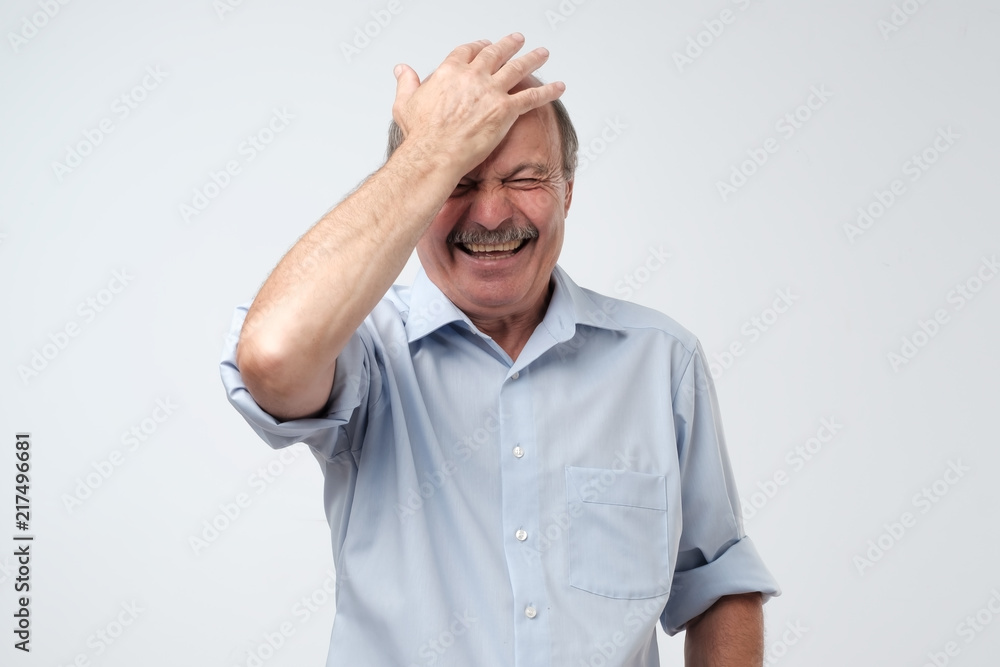 Mature european man laughing on funny joke Mature european man laughing on funny joke
