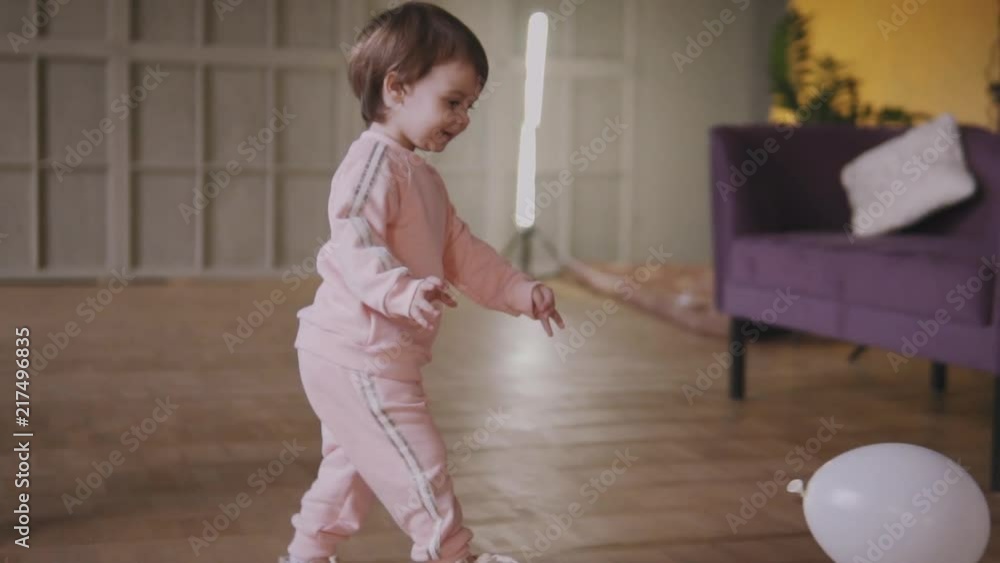 Sisters twins play together running around the house and riding on a swing Sisters twins play together running around the house and riding on a swing