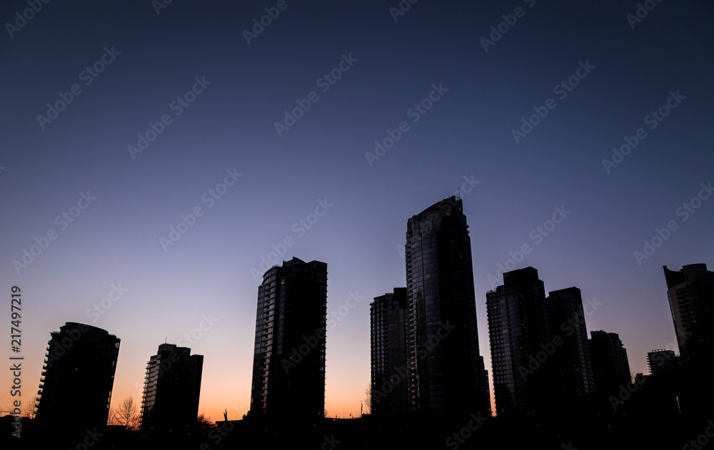 Silhouette of buildings at sunset in Downtown Vancouver.