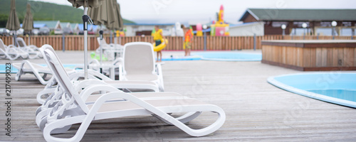 Banner Wooden deck beach sea ocean resort sun lounger umbrella hotel pool sky sunrise.