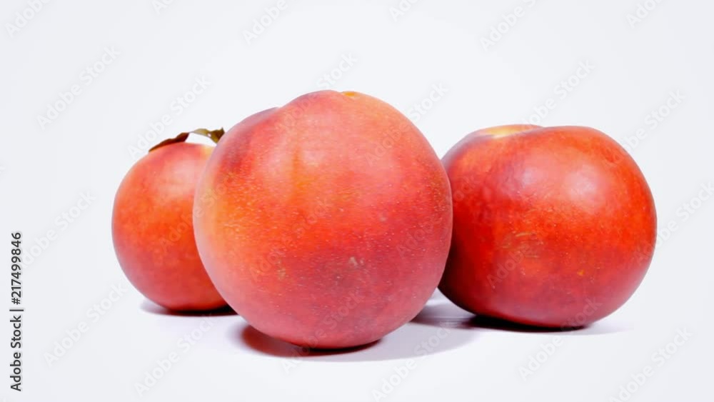A group of ripe peaches on a rotating surface. Front shot.
A group of ripe peaches on a rotating surface. Front shot.