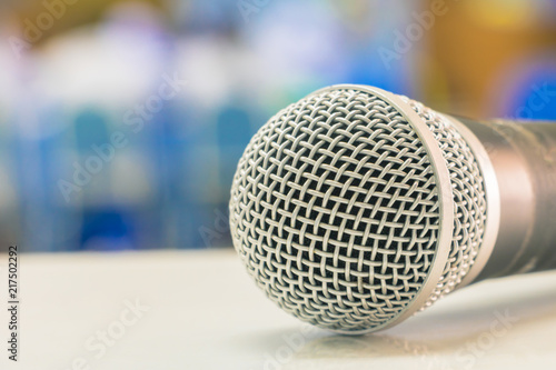 Close up microphone wireless on the white table in business conference interior seminar meeting room and Background blur