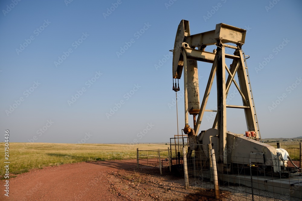 Crude oil pump jack operating in the rural fields of the Powder River Basin in Northeast Wyoming Crude oil pump jack operating in the rural fields of the Powder River Basin in Northeast Wyoming