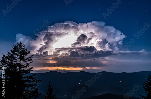 Tableau sur toile A huge thunderstorm with active lightning lighting up the clouds is seen from th