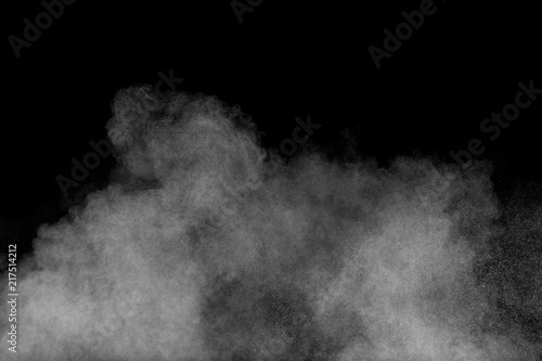 Abstract white powder explosion. White dust debris isolated on black background.