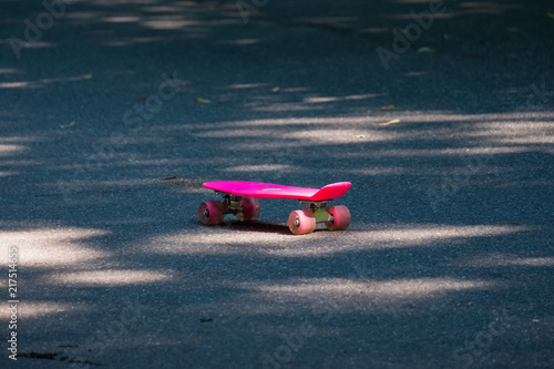 pink children's skateboard in the park