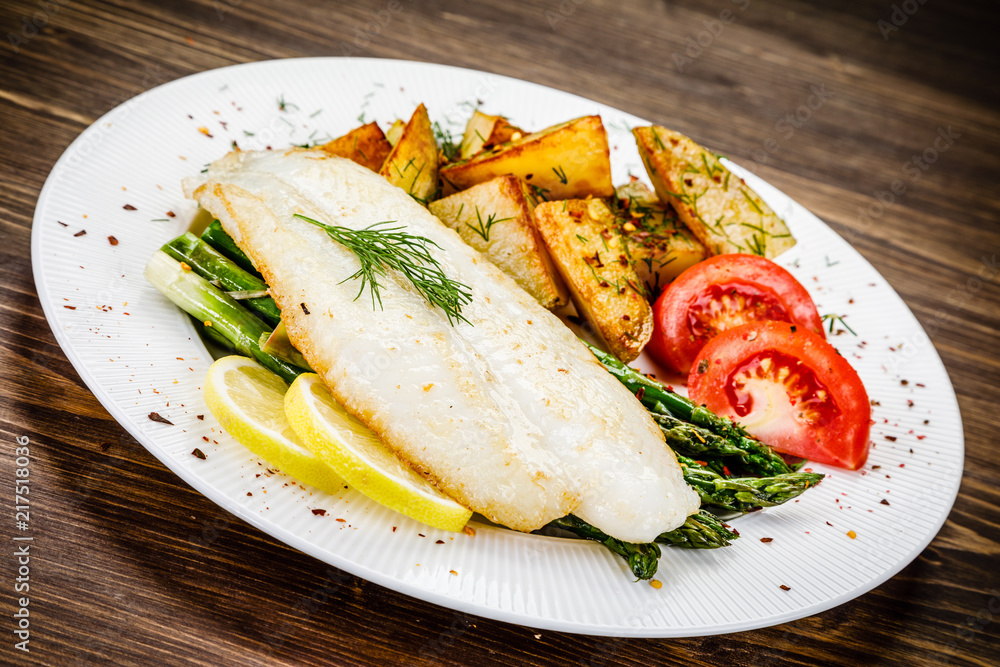 Fish dish - fried fish fillet with fried potatoes and vegetables Fish dish - fried fish fillet with fried potatoes and vegetables