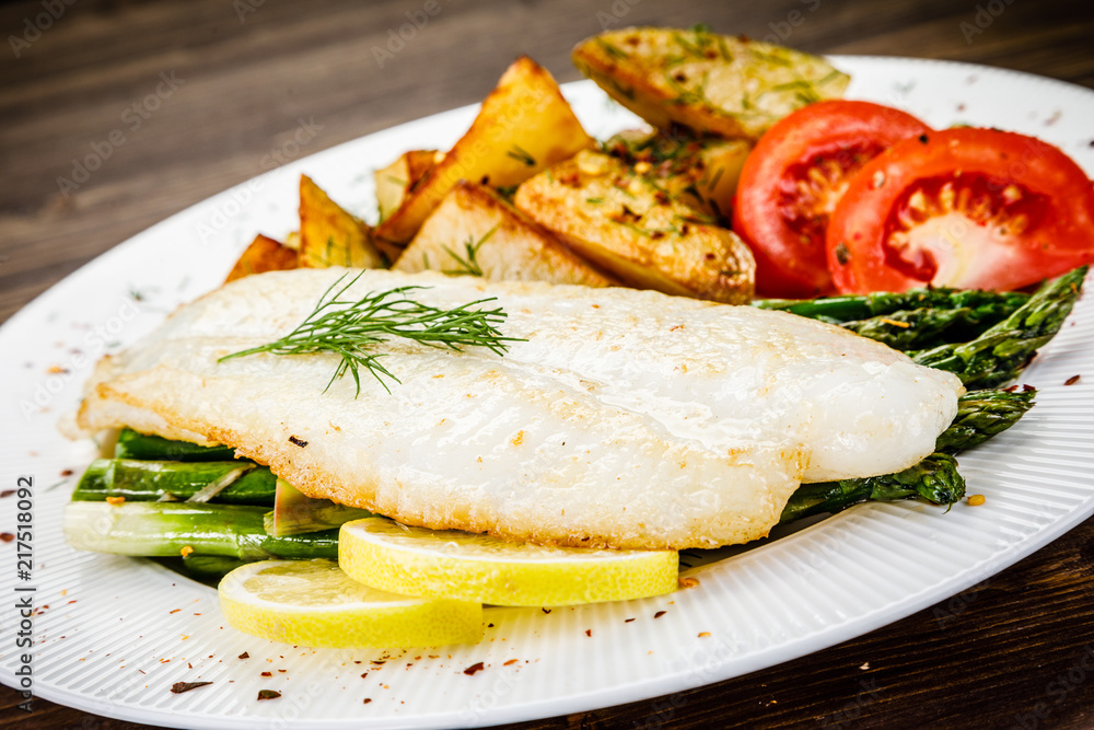 Fish dish - fried fish fillet with fried potatoes and vegetables Fish dish - fried fish fillet with fried potatoes and vegetables