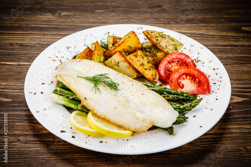 Fish dish - fried fish fillet with fried potatoes and vegetables
