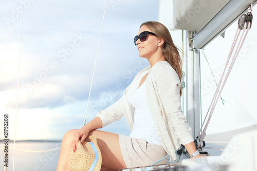 Relaxing attractive young woman on vacation sitting on yacht. © ty