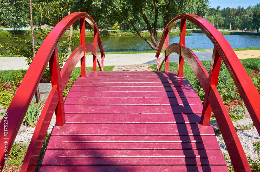 wooden red decorative bridge across the pond wooden red decorative bridge across the pond