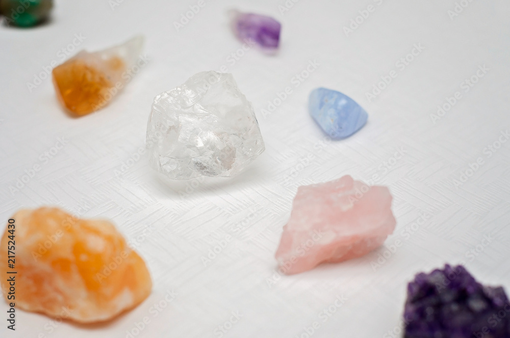 Healing crystals on a white table including: Amethyst Point and Cluster, Clear Quartz, Citrine, Calcite and Rose quartz. Gemstones are full of healing energy and good vibes. Healing crystals on a white table including: Amethyst Point and Cluster, Clear Quartz, Citrine, Calcite and Rose quartz. Gemstones are full of healing energy and good vibes.