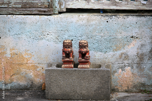 okinawa street view with the traditional lion rock statue photo