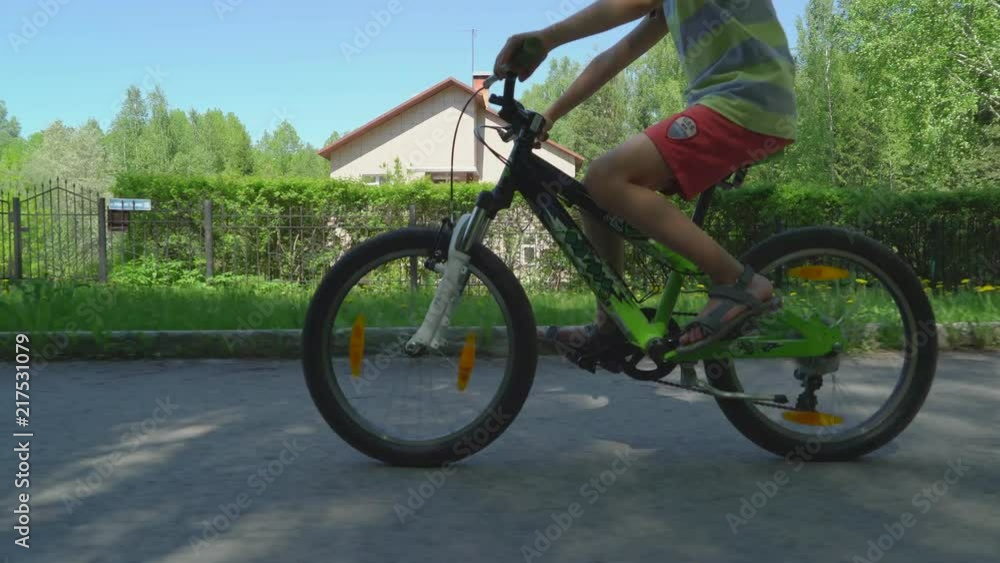 Child Cycling. Young boy rides a bicycle down the street in sunny spring day. Child Cycling. Young boy rides a bicycle down the street in sunny spring day.