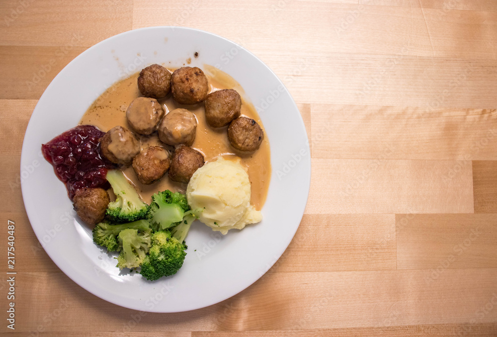 Swedish meatballs with mashed potato placed on the wooden table with blank space. Swedish meatballs with mashed potato placed on the wooden table with blank space.