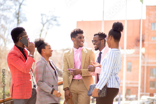 afro guests are waiting for a bride and a groom in the street with modern buildings. photo