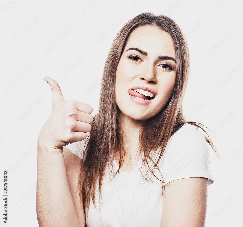 Happy young cheerful woman showing thumbs up isolated on white background Happy young cheerful woman showing thumbs up isolated on white background